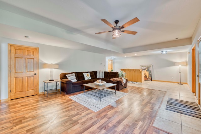 living room with light wood-type flooring and ceiling fan