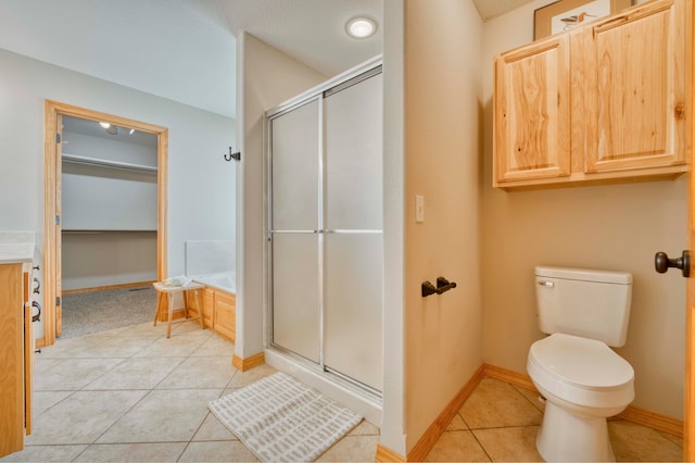 bathroom with tile patterned floors, independent shower and bath, and toilet