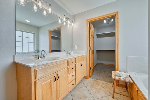 bathroom with tile patterned flooring, vanity, and a tub to relax in