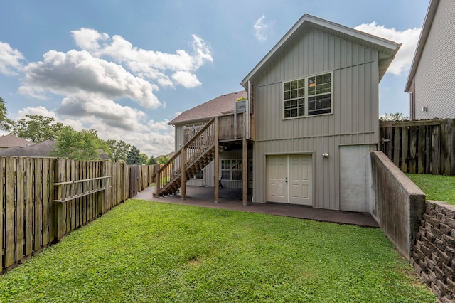 back of house with a lawn and a wooden deck