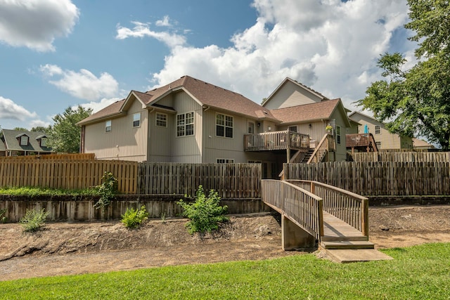 rear view of house featuring a wooden deck