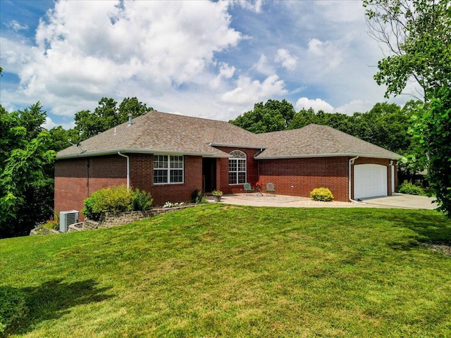 ranch-style home featuring a garage, a front yard, and central air condition unit