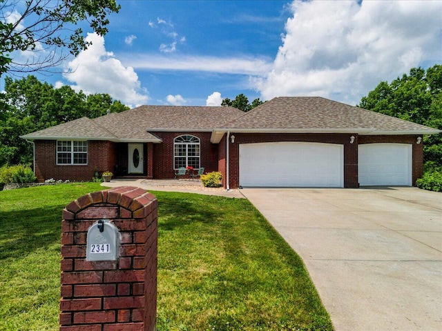 ranch-style home with a garage and a front lawn