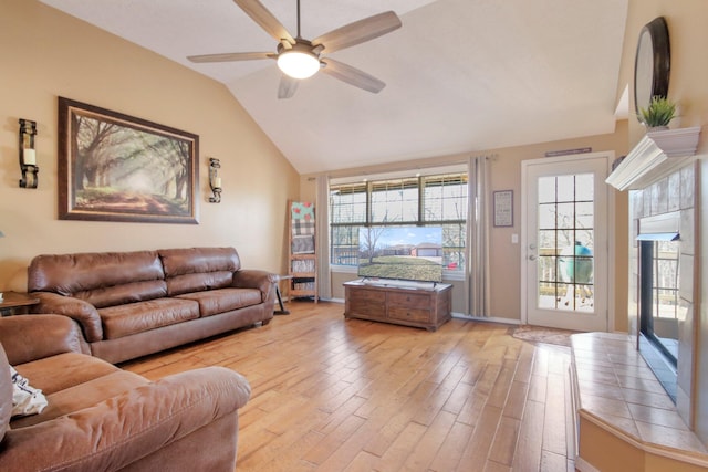 living room featuring vaulted ceiling, ceiling fan, and light hardwood / wood-style flooring