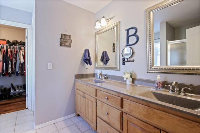 bathroom with vanity, an enclosed shower, and tile patterned floors