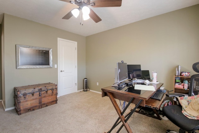 carpeted home office with ceiling fan