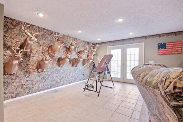 tiled bedroom featuring access to exterior and a textured ceiling