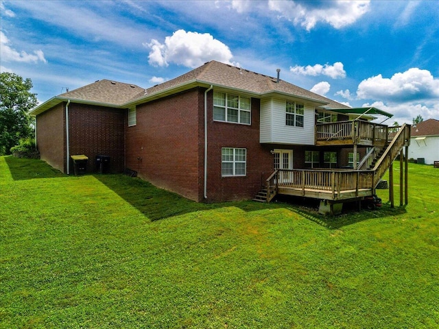 back of property featuring a lawn and a deck