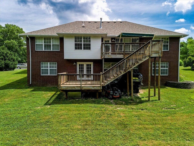 rear view of property featuring a yard and a deck