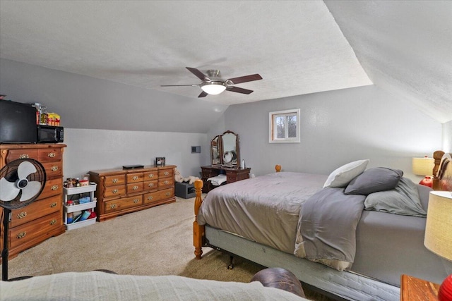 bedroom with carpet flooring, ceiling fan, lofted ceiling, and a textured ceiling