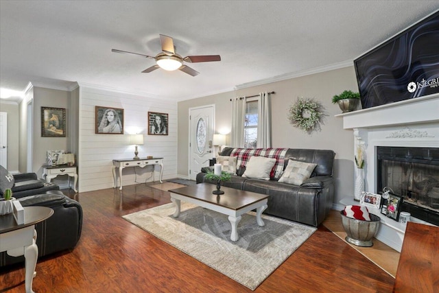 living room with hardwood / wood-style floors, ceiling fan, and crown molding