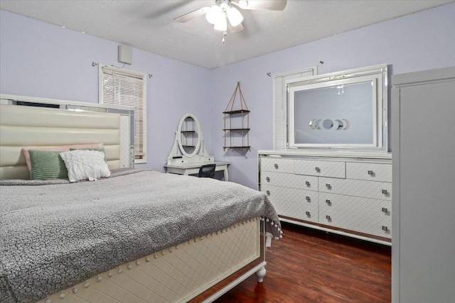 bedroom with ceiling fan and dark wood-type flooring