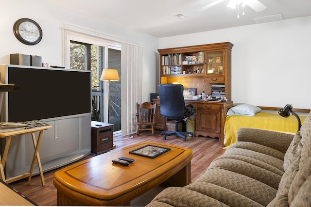 living room featuring ceiling fan and hardwood / wood-style flooring