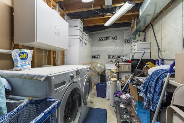 laundry room featuring washing machine and dryer and cabinets