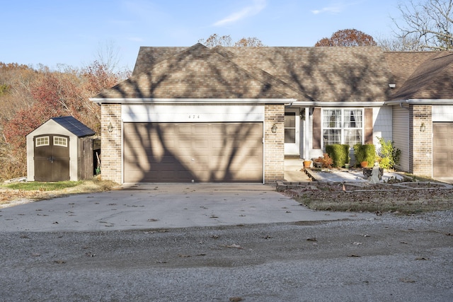 view of front of house featuring a storage unit and a garage