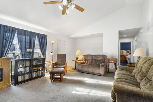 carpeted living room with ceiling fan and high vaulted ceiling