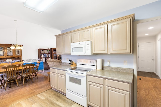 kitchen with light hardwood / wood-style flooring, cream cabinetry, a chandelier, decorative light fixtures, and white appliances