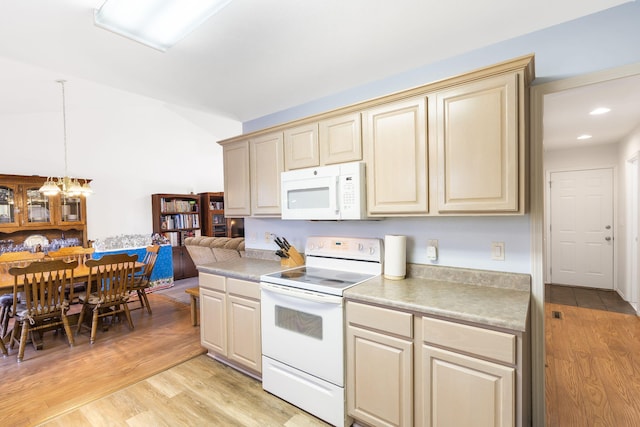 474 Woodland Dr E, Branson, MO 65616 - kitchen with white appliances, cream cabinets, light wood-style flooring, light countertops, and vaulted ceiling