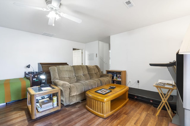 living room featuring ceiling fan and dark hardwood / wood-style flooring