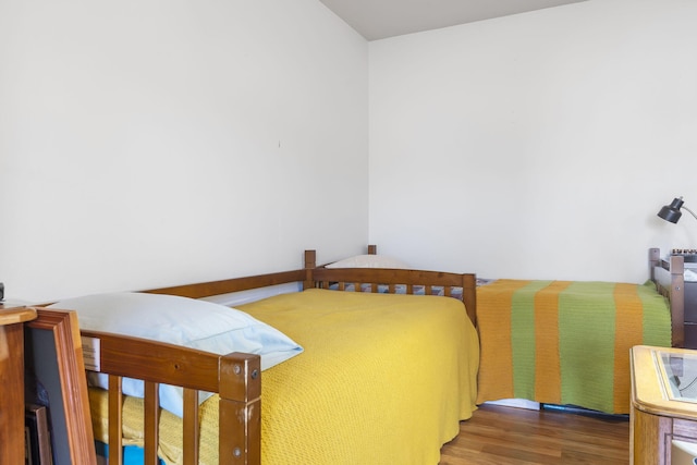 bedroom with dark hardwood / wood-style flooring