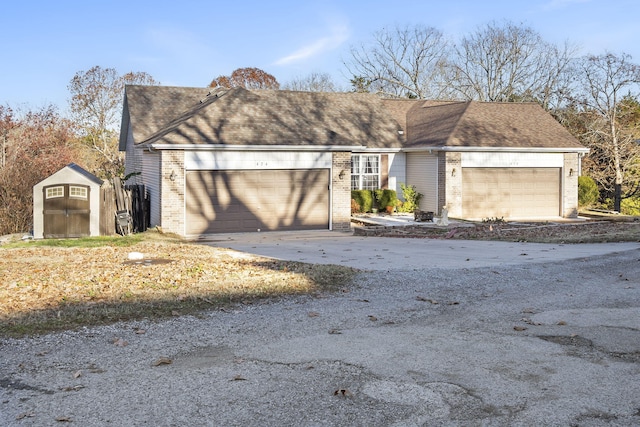 view of front of property with a storage unit and a garage