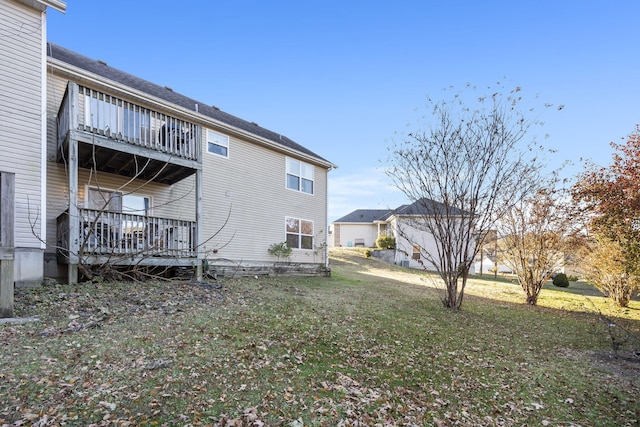 rear view of property featuring a lawn