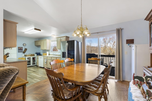 474 Woodland Dr E, Branson, MO 65616 - dining room featuring a chandelier, light wood finished floors, vaulted ceiling, and wine cooler