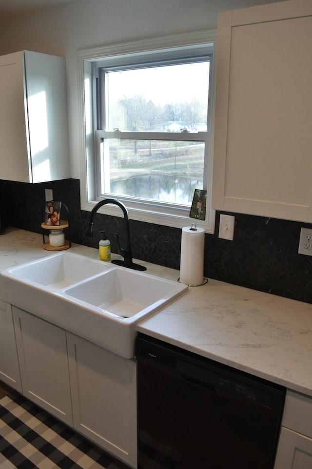 kitchen with decorative backsplash, white cabinetry, and black dishwasher