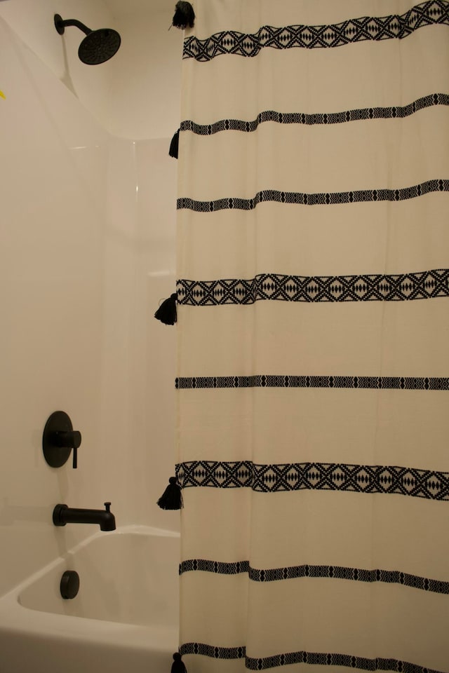 bathroom with shower / bathtub combination with curtain