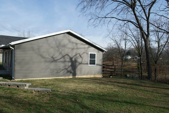 view of side of property with a yard