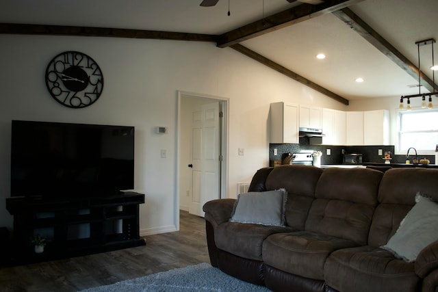 living room featuring ceiling fan, sink, lofted ceiling with beams, and dark hardwood / wood-style floors