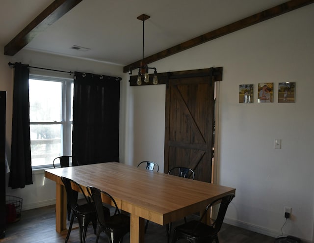 dining room with a barn door, lofted ceiling with beams, and dark hardwood / wood-style floors