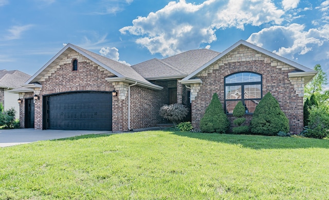 view of front facade with a garage and a front lawn