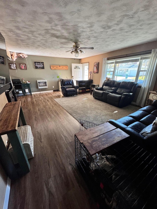 living room with ceiling fan, a textured ceiling, and hardwood / wood-style flooring