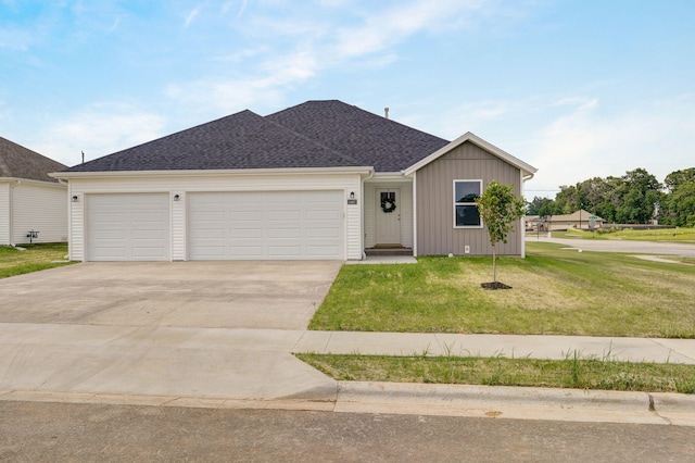 ranch-style house with a garage and a front lawn