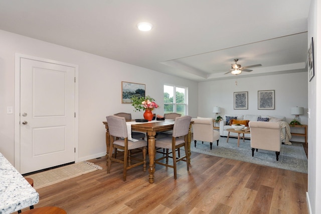 dining area featuring hardwood / wood-style floors and ceiling fan