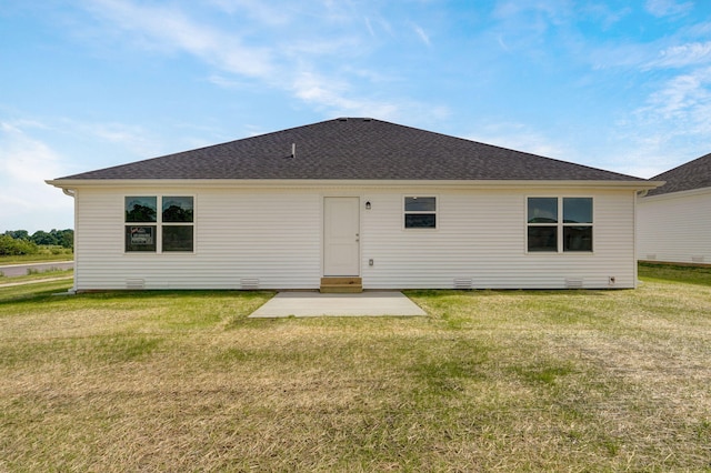 back of property with a patio and a lawn