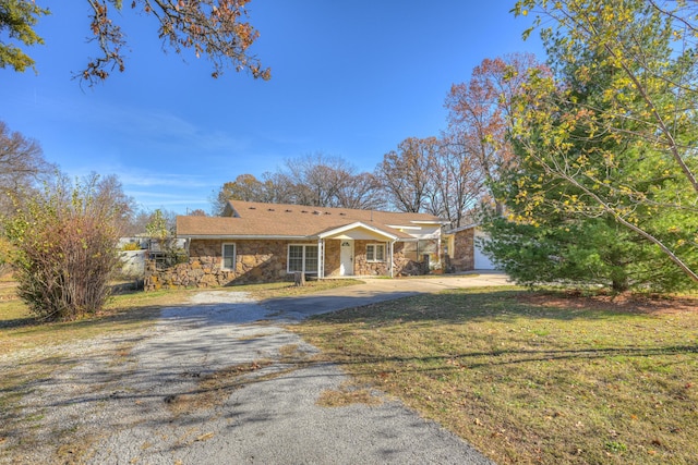 ranch-style home with a front yard