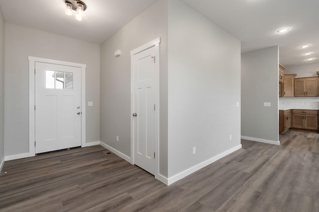 entryway with dark hardwood / wood-style floors