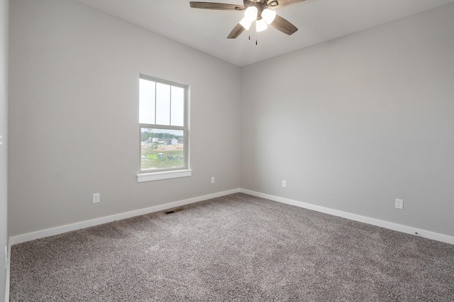 empty room with ceiling fan and carpet floors