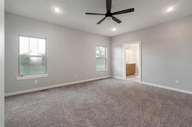 carpeted empty room featuring ceiling fan