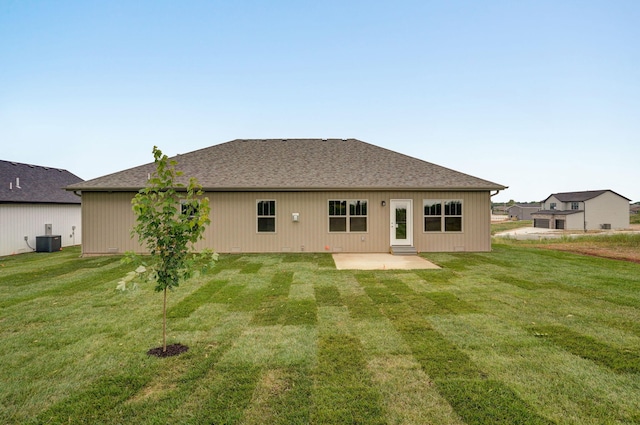 back of property featuring a lawn, cooling unit, and a patio