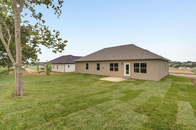 back of property with a patio area and a yard