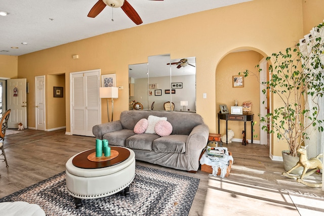 living room featuring ceiling fan and wood-type flooring