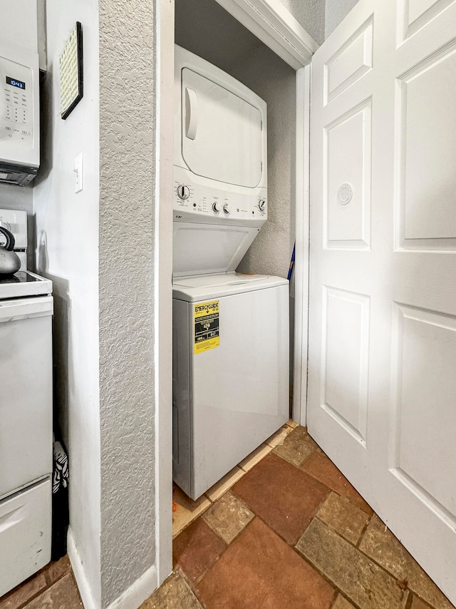 laundry room with stacked washer / drying machine