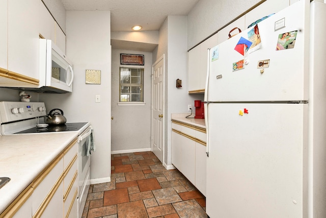 kitchen with white appliances and white cabinetry