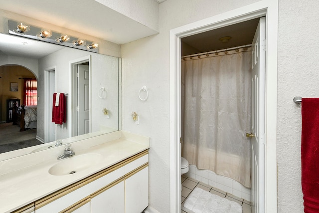 bathroom featuring tile patterned floors, vanity, and toilet