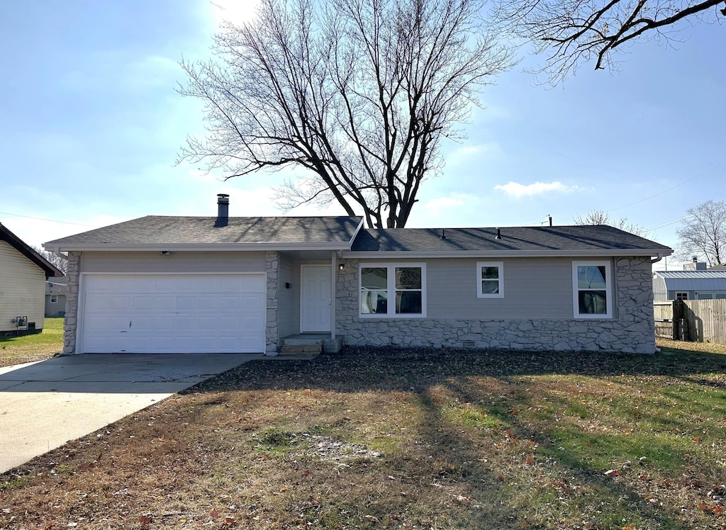 ranch-style home with a front yard and a garage