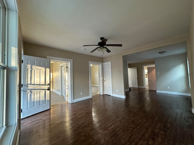 unfurnished living room with ceiling fan and dark hardwood / wood-style flooring