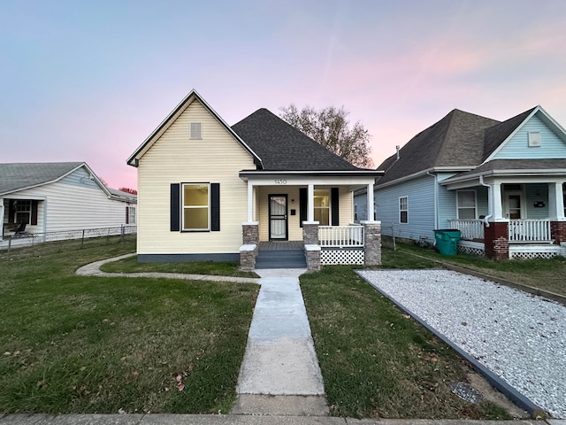 view of front of property with a lawn and covered porch